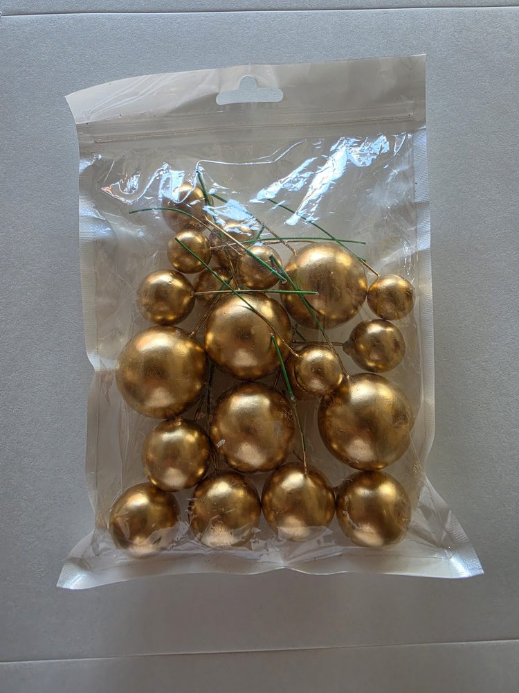 Bolsa con esferas doradas de varios tamanos montadas en alambre