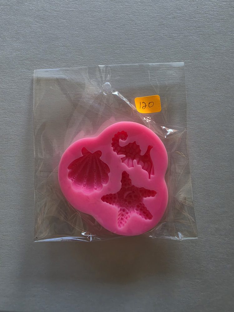 Molde de silicón rosado con tres cavidades: concha, caballito de mar
