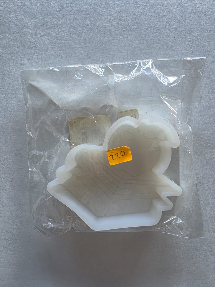 Molde de silicón blanco con figura de corazón sobre una base