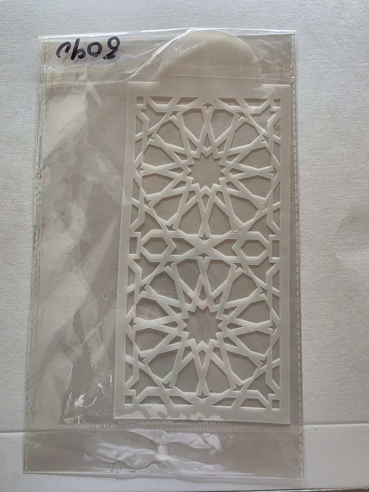 Esténcil de plástico blanco rectangular con patrón geométrico calado